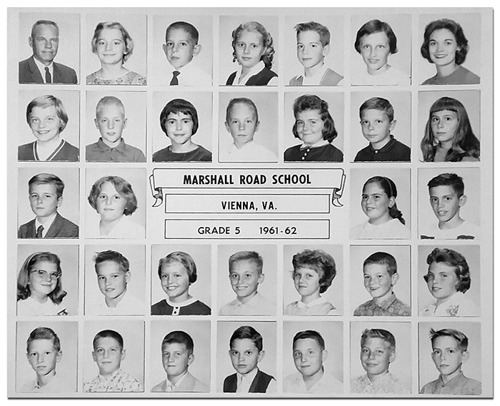 Black and white class photograph showing a grade five classroom at Marshall Road Elementary School from the 1961 to 1962 school year. Among those pictured is Dottie Gabig. The principal, Robert F. Jarecke, can be seen in the top left corner. There were 30 children in the class. 